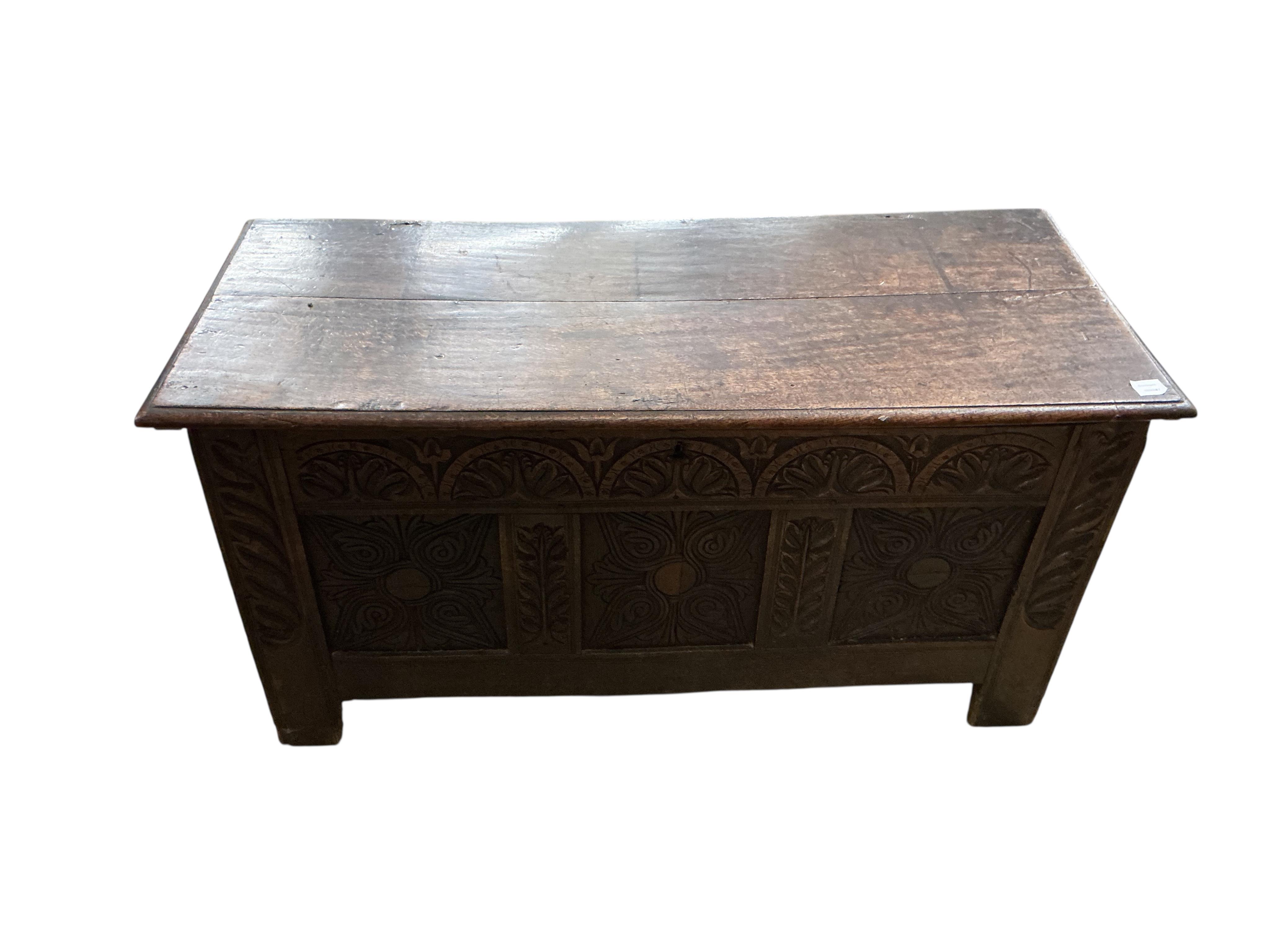 An 18th century carved oak coffer, width 132cm, depth 56cm, height 64cm